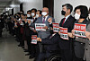 Lawmakers from the main opposition People Power Party (PPP) stage a rally in front of a meeting room for the Legislation and Judiciary Committee of the National Assembly in Yeouido, western Seoul, on Monday. They were protesting the attempted revision to the Corruption Investigation Office for High-ranking Officials (CIO), calling the legislation a shield for pro-government figures and a sword against those who oppose the administration. [OH JONG-TAEK]