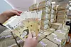 Stacks of 50,000 won notes at Hana Bank in Myeong-dong, Seoul. The government said it has collected 43.6 trillion won more taxes in the first five months of 2021 compared to the same period thanks to rising real estate prices, bullish stock market and robust export. [YONHAP]