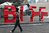 A passerby walks across the Busan International Film Festival (BIFF) logo in front of the Busan Cinema Center in Haeundae District, eastern Busan, on May 24. [NEWS1]