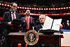 U.S. President Donald Trump holds an executive order announcing the U.S. withdrawal from the Paris Agreement he just signed during the inaugural parade inside Capital One Arena in Washington, D.C. on Jan. 20. [AFP/YONHAP]