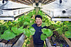 Dream Farm CEO Park Hyang-jin poses with wasabi leaves in a smart farming “cube” where wasabi is cultivated in a human-free, app-controlled environment, on April 3 in Sacheon, South Gyeongsang. [PARK SANG-MOON]