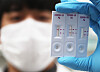An SD Biosensor researcher conducts test at the test kit maker's facility in Suwon, Gyeonggi. [YONHAP]