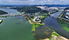 A section of Nakdong River, left, is filled with toxic algae bloom as a joint civil defense drill, simulating a response to water pollution from drone attacks, takes place near Geumho River in Daegu, North Gyeongsang, on Tuesday. [YONHAP]