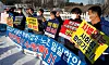 An association representing delivery contractors hold a press event in front of the National Assembly on Thursday. [NEWS1]