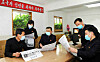 North Korean officials read leader Kim Jong-un's New Year's message, as described in a state media photograph from Sunday. [NEWS1]