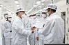 President Moon Jae-in, left, being briefed on EV batteries during his visit to SK Innovation's plant in Georgia, on Saturday. SK Group Chairman Chey Tae-won, second from right, attended the tour. [YONHAP]