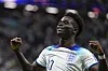 Bukayo Saka celebrates after scoring his side's third goal during a round of 16 match between England and Senegal at the 2022 FIFA World Cup at Al Bayt Stadium in Al Khor, Qatar on Sunday. [AP/YONHAP]