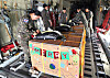 South Korean Air Force personnel secure boxes containing humanitarian supplies to be airdropped to remote islands in Micronesia from a C-130 transport plane on Sunday as a part of the weeklong U.S.-led Operation Christmas Drop. [AIR FORCE]