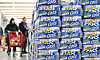 Cass beer packs are shown beside customers shopping at a wholesale store in Seoul on March 30 [NEWS1]