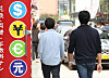 Pedestrians walk past a currency exchange shop in Myeong-dong, central Seoul, on Oct. 26. [YONHAP]