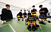 Players control humanoid robots with cat faces in a football game at the Y Education Fair, held at Yangcheon Park, western Seoul, on Thursday. [YONHAP]