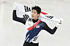 Hwang Dae-heon holds the Korean flag after winning silver in the men’s 1,500-meter short track final at the Milano Ice Skating Arena during the 2026 Milan-Cortina Winter Olympics on Feb. 14. [YONHAP]