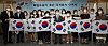 Descendants of independence fighters against imperial Japan pose holding the Korean national flag with Justice Minister Park Beom-kye, center, at the Justice Ministry in the central government complex in Gwacheon, Gyeonggi, on Thursday, after they received the certificate of Korean nationality. [YONHAP]
