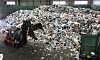 An employee of a waste-sorting firm separates the accumulated waste with an excavator at a recycling center inside a park in Songpa District, southern Seoul. [NEWS1]