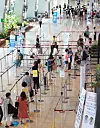 Travelers wait in line at the Gimpo International Airport on Thursday. According to data from the Ministry of Land, Infrastructure and Transport on Thursday, the number of travelers in the first half of the year declined by 29.3 percent on-year to 16.67 million people. The number of travelers using domestic flights, however, increased by 45.8 percent to 15.48 million people over the same period. [YONHAP]