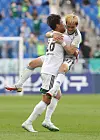 Jun Amano of Jeonbuk Hyundai, right celebrates with Hong Jung-ho after scoring for Jeonbuk during a match against Ulsan Hyundai at Munsu Football Stadium in Ulsan on Sunday. [YONHAP]
