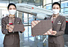 Asiana Airlines flight attendants show tablet sleeves made from used uniforms. [ASIANA AIRLINES]