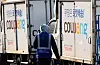 A Coupang Logistics Center worker is seen next to Coupang delivery trucks in Seoul on Dec. 17. [YONHAP]