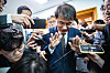 Rho Tae-ak, center, chairman of the National Election Commission (NEC), is surrounded by reporters after leaving a meeting of the NEC at the agency's headquarters in Gwacheon, Gyeonggi, Friday. [NEWS1]