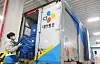 A CJ Logistics delivery worker loads packages into a delivery truck. [CJ LOGISTICS]
