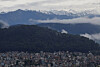 A snowcapped mountain range emerges over the valley as monsoon clouds clear following heavy rainfall in Kathmandu, Nepal, Oct. 5. [REUTERS/YONHAP]