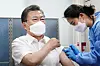 President Moon Jae-in receives his first dose of the AstraZeneca vaccine at a public health center in Jongno District, central Seoul, on Tuesday. [JOINT PRESS CORPS]
