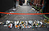 Flowers to pay respect to the victims of the Itaewon tragedy are laid in front of the police's access restriction line near the incident site on Monday. [YONHAP]