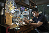 Metal artist Hyun Kwang-hun focuses on assembling watch parts at his studio located in Huam-dong, Yongsan District, central Seoul.  [PARK SANG-MOON]