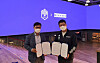 Kim Hyun-soo (left), director of Megabox's multiplex division, and DWG KIA owner Lee Yu-young pose for the cameras with copies of the memorandum in hand. [MEGABOX]