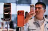 A man takes images of the new iPhone 17 Pro smartphones as they are displayed at the Apple store in Beijing's Sanlitun area during the start of sales on Sept. 19. [REUTERS/YONHAP]