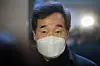 Ruling Democratic Party Chairman Lee Nak-yon answers questions from the press upon exiting the party's Supreme Council meeting at the National Assembly in Seoul on Sunday. [NEWS1]