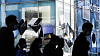 Passengers pass by a Samsung Electronics retail shop in Seoul. [NEWS1]