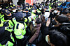 Police and members of the Korean Confederation of Trade Unions face off as investigators from the National Intelligence Service and National Police Agency raid the group's headquarters in Jung District, central Seoul Wednesday morning. [YONHAP]