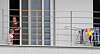 Two Afghans are pictured Sunday on a balcony of a facility in Jincheon County, North Chungcheong, where the evacuated Afghans are staying quarantined for two weeks, after which they will start a procedure to settle in Korea. The Korean government evacuated 390 Afghans out of Kabul last week. They are people who have worked with the Korean government and their families. [NEWS1]
