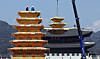 Workers install a monumental pagoda celebrating Buddha's Birthday at Gwanghwamun Square in Jongno District, central Seoul, on March 31. [YONHAP]
