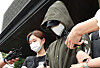 A woman accused of killing her newborn and abandoning the body near a stream in Daejeon leaves Suwon Nambu Police Precinct on Friday to be handed over to the prosecution. [YONHAP]