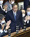 Yoshihide Suga, center, stands after being elected Japan's new prime minister in Tokyo on Wednesday. Suga, the new leader of the ruling Liberal Democratic Party, was chosen to succeed Shinzo Abe in an extraordinary parliamentary session on Wednesday. [YONHAP]