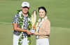 Kim Si-woo poses with his wife Oh Ji-hyun and the trophy after putting in to win on the 18th green during the final round of the Sony Open in Hawaii on Jan. 15. [GETTY IMAGES]