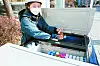 A young Fresh Manager, the job title for sellers of the Korean Yakurt products, arranges dairy goods on her mobile refrigerated cart [HY]