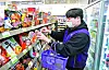 Song Yoo-seok, 27, the manager of CU's Junghwa Station branch in eastern Seoul, arranges products on to the stalls on March 7. [KANG JEONG-HYEON]