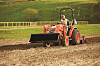A man rides a tractor made by Daedong in North America. [DAEDONG]