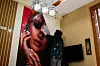 An Afghan beautician removes a poster in a beauty salon in Kabul, Afghanistan, July 24, 2023. [REUTERS/YONHAP]