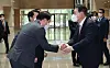 President-elect Yoon Suk-yeol, right, shakes hands with SK Group Chairman Chey Tae-won during his visit to SK bioscience headquarters in Seongnam, Gyeonggi, on Monday. [YONHAP]