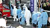 Students infected with Covid-19 at the TCS International School in Gwangsan District, Gwangju, board a bus to be transferred to a treatment center after more than 110 people were diagnosed with the virus as of Wednesday. [YONHAP]