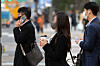 An office worker goes to work with a cup of coffee in hand in Seoul. [NEWS1]