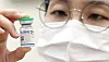 A medical staff holds a vial of SKYCovione vaccine, developed and manufactured by SK bioscience, at a public health center in Incheon [YONHAP]