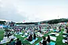 Festivalgoers at The Beautiful Mint Life 2021 music festival watch performances on picnic mats Saturday at Olympic Park in southern Seoul. The Beautiful Mint Life 2021 is Korea's first large-scale outdoor music festival to be held in a year and eight months since the Covid-19 pandemic broke out early last year. All visitors must use a self-testing kit to help ensure they do not have the virus. [NEWS1]