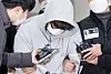 Lee Seok-joon, a 26-year-old who murdered his ex-girlfriend's mother, is questioned by reporters as he leaves the Songpa Police Precinct in Songpa District, southern Seoul, on Dec. 17, 2021. [YONHAP]
