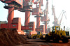 Workers transport soil containing rare earth elements for export at a port in Lianyungang, Jiangsu province, China October 31, 2010. [REUTERS]