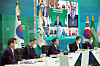 Korean President Moon Jae-in, center, flanked by aides, speaks during a virtual summit of the Group of 20 (G-20) leaders of major economies at the Blue House on Saturday. [JOINT PRESS CORPS]